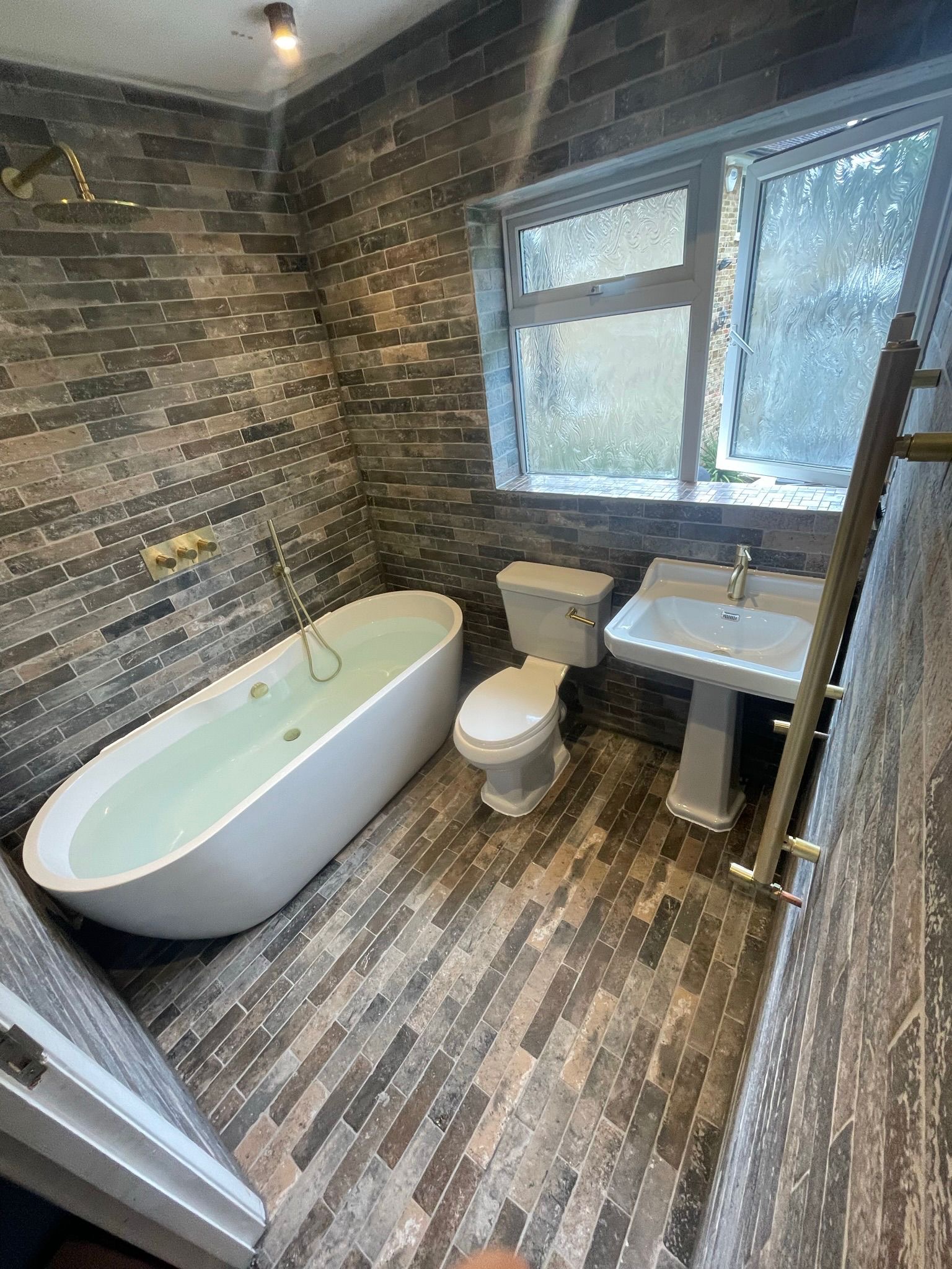 Rustic bathroom with brick tiles